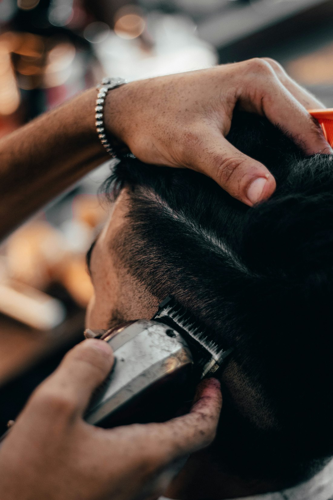 Barber lining up a fresh fade with clippers